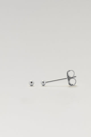 A pair of silver barbell stud earrings, with one earring shown front-facing displaying a round silver ball stud and the other shown from the side displaying the butterfly back, on a light gray background.