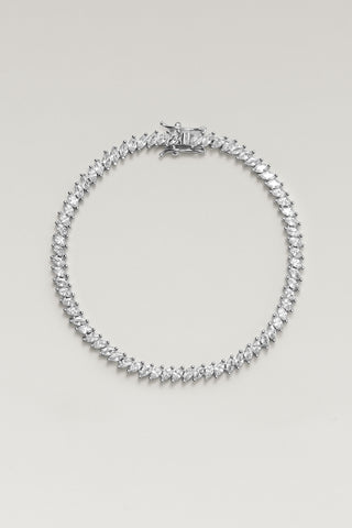 Nico tennis bracelet, silver plated, lying in a circle with its box clasp and angled marquise-cut cubic zirconia