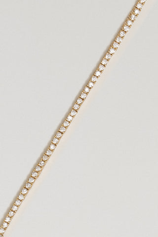 Clara mini tennis bracelet, gold plated, diagonal close-up of the claw-set round cubic zirconia