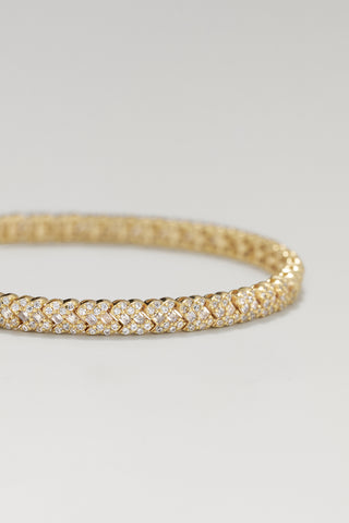 Roxy tennis bracelet, gold plated, angled close-up of the woven X-pattern cubic zirconia line