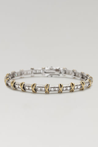 Renata bracelet, rhodium and gold plated, lying flat with cubic zirconia links, gold cross details and a box clasp