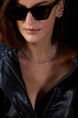 Model in sunglasses and a black leather jacket wearing the two-tone Renata necklace