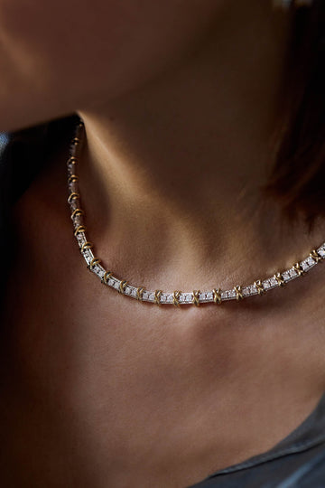 Renata necklace, rhodium and gold plated, worn at the collarbone showing the cubic zirconia links and gold crosses