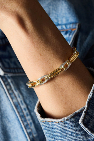 Allegra bracelet, gold and rhodium plated, close-up on the wrist over a denim sleeve