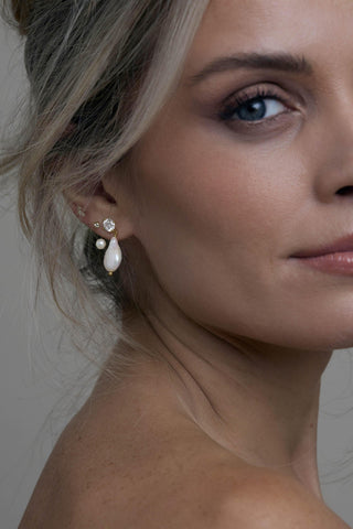Close-up of Amelie pearl drop earrings worn with bridal styling