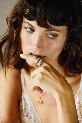 Aurora gold gemstone ring worn on finger in lifestyle close-up