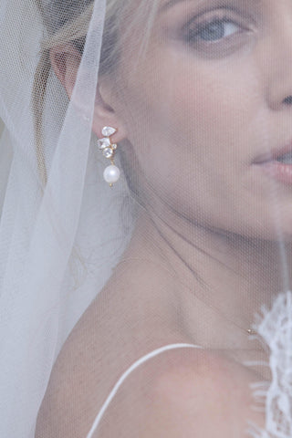 Pearl drop Belle earrings styled with bridal veil and wedding dress