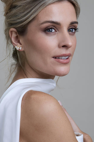 Close-up of Elsie gold bridal stud earrings with crystal detailing