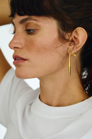 Close-up of Noa gold statement earrings