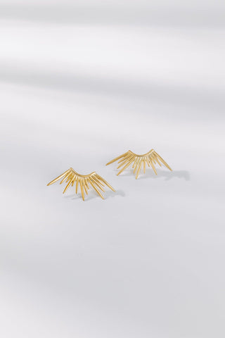 Sunset gold stud earrings featuring a fan-shaped radiant design on a white background