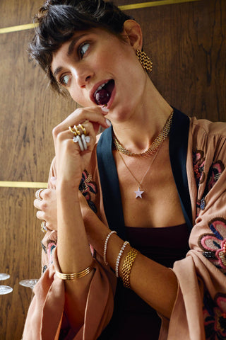 Vivienne Earrings worn by model, featuring bold woven matte gold links and contemporary drop earring silhouette.