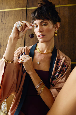 Vivienne Necklace worn by model, highlighting sculptural woven matte gold chain and luxury gold finish.