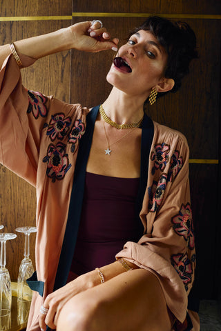 Model wearing Vivienne Necklace, a bold woven matte gold chain necklace styled at the collarbone with layered gold jewellery.